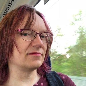 Anna on train with pink hair