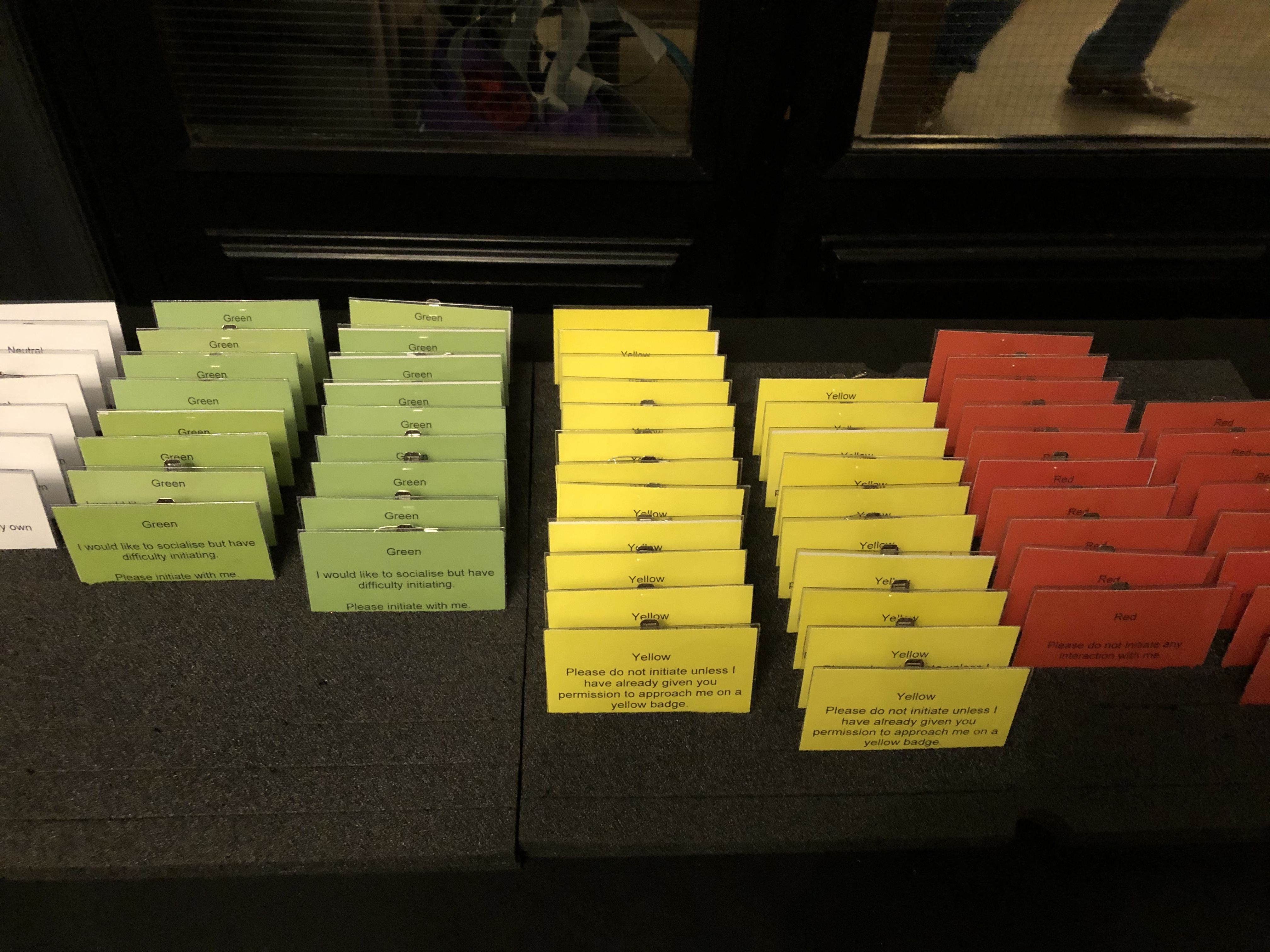 White, green, yellow and red interaction badges on a table