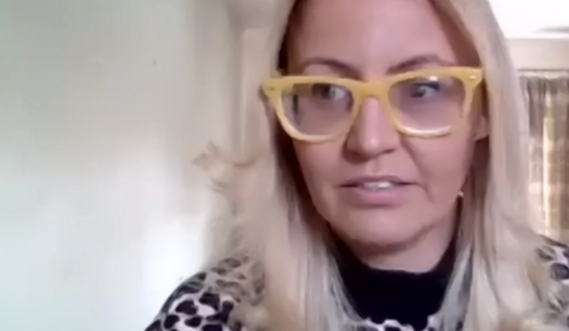 Carly Jones talking on Zoom from her home.