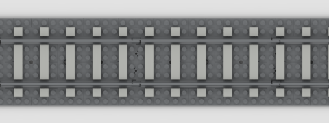 A straight stretch of grey LEGO track, with matching plates used as ballast. Light grey tiles are placed out of alignment with the LEGO sleepers, but on the grid, to create the effect of one-stud-wide sleepers with two-stud-wide spaces.