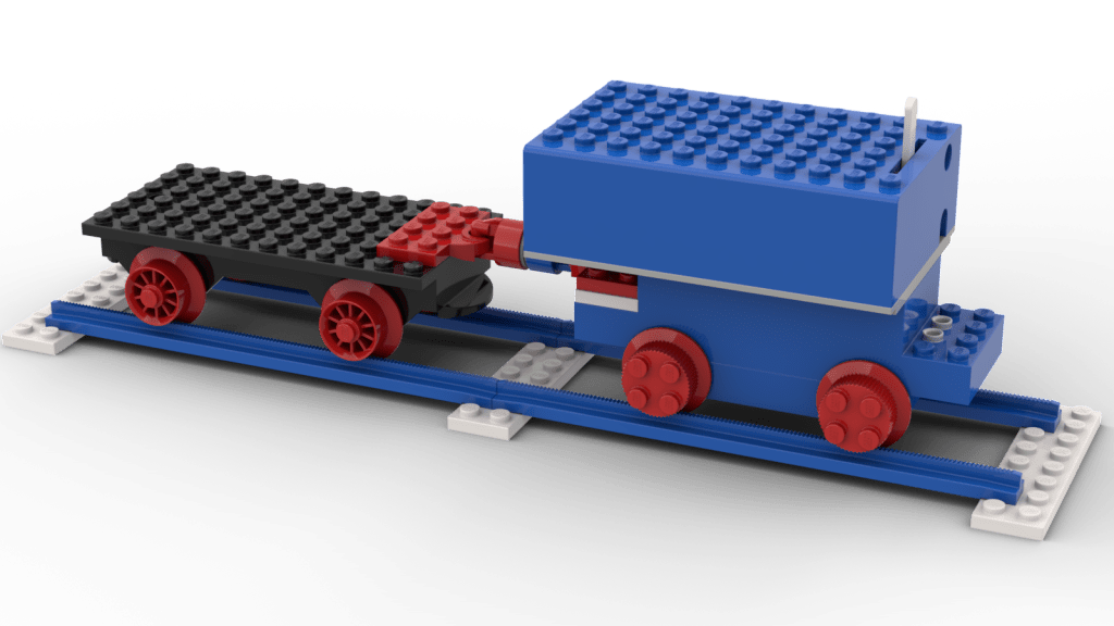 An early 1970s train constructed from a simple engine and wagon. The engine is a blue 4-stud-wide motor with four 2-by-2-stud red wheels plugged in, and piggy-backed on top, a blue 6-by-11-stud battery box with a forward/off/reverse switch sticking up. The wagon is a black 6-by-12 plate with four red spoked wheels mounted underneath. The two are coupled using old-style red and blue couplers with glued-in magnets. They sit on a piece of straight track made from four blue serrated-edge rails sitting on three 2-by-8 white plates. Built in LEGO BrickLink Studio.